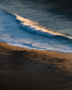 A gallery print by Enzo Benzoni: golden mist over a coastline, the signature grade